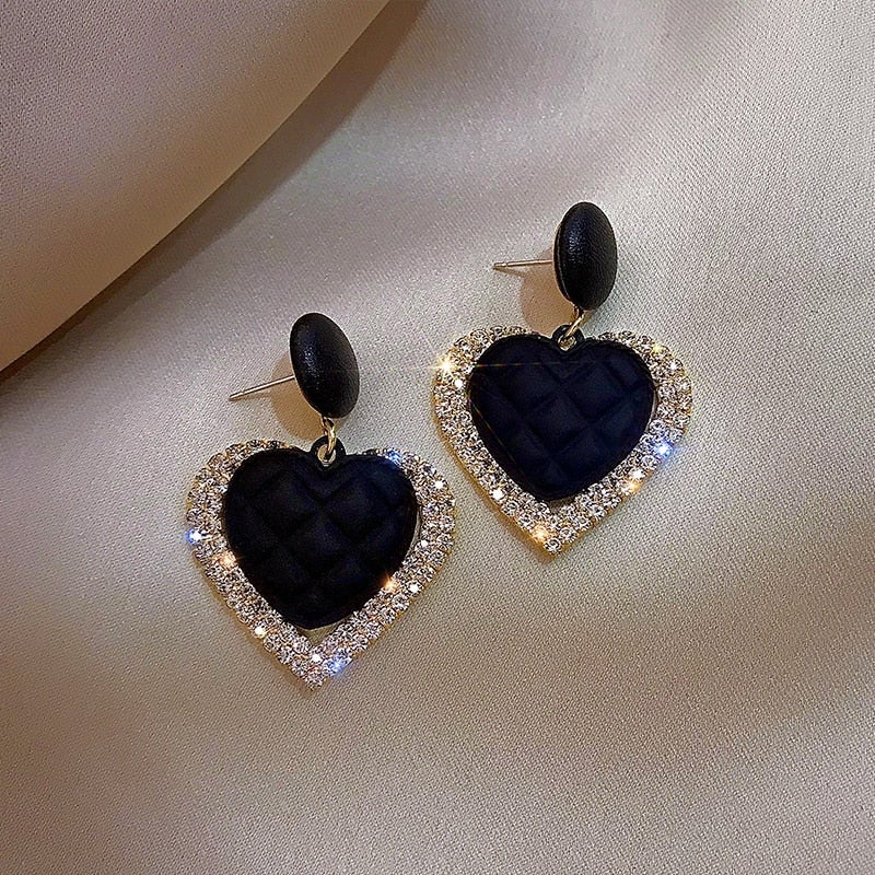 Gold earrings with dark heart